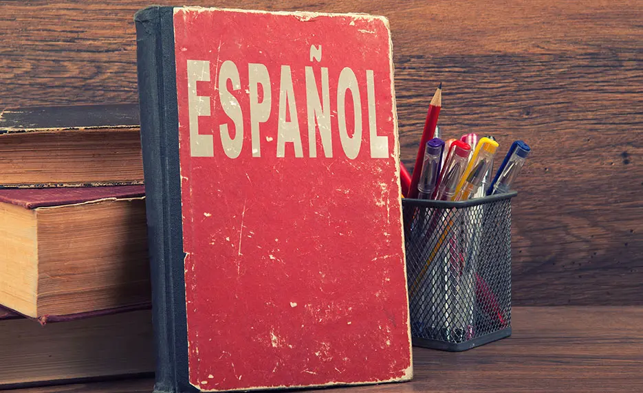 A photo of a red book with the Spanish word "Espanol" on the cover.